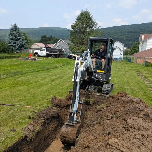 Jerry Riviello excavating a residential underground utility trench