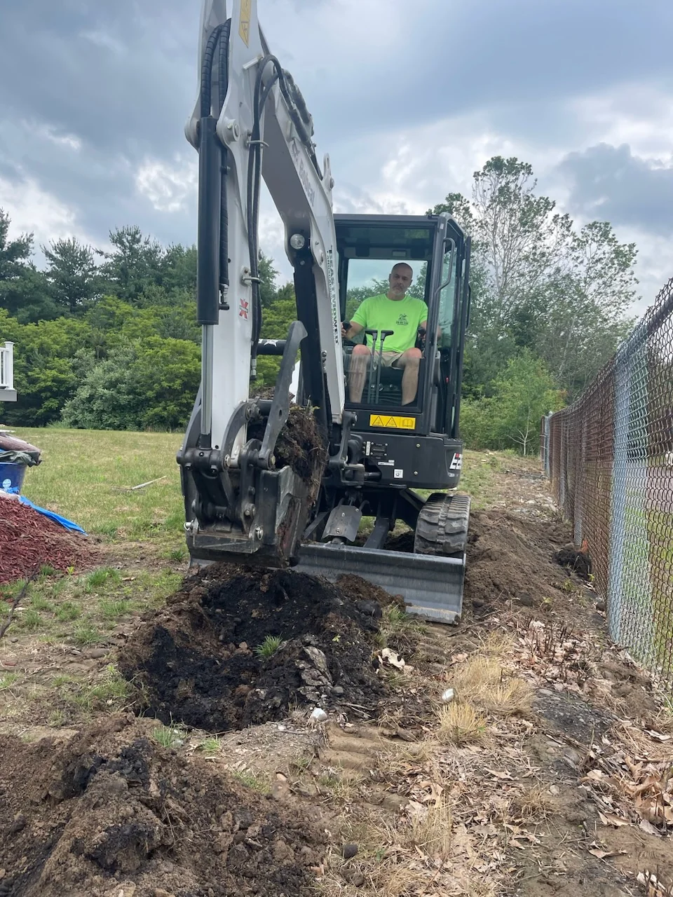 Jerry Riviello operating an excavator for residential water and sewer work