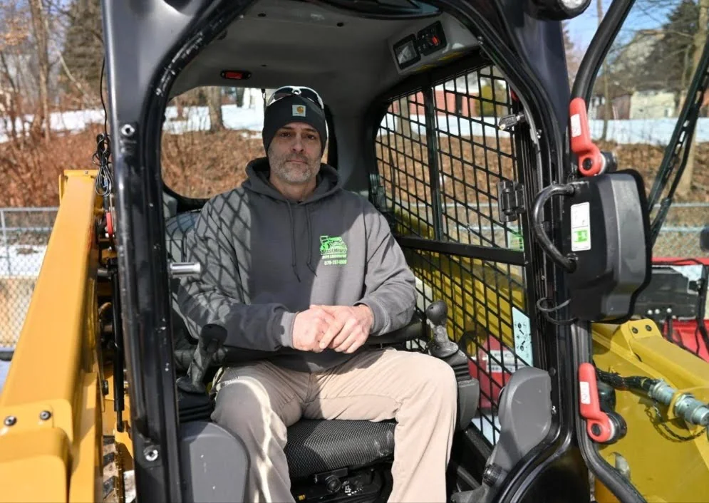 Jerry Riviello operating Caterpillar skid steer equipment