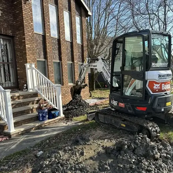 1. Mini excavator beginning the Eynon water-line excavation by Affordable Plumbing NEPA